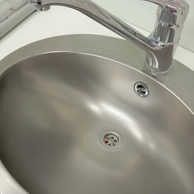 The same stainless steel sink after cleaning, photographed from the opposite side.
